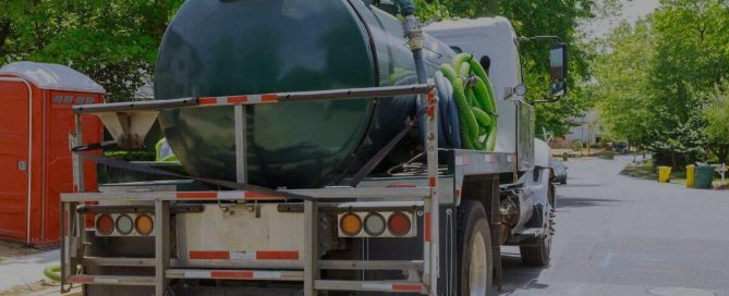 back of septic pump truck on a street | equipment needed to run a septic tank company | ServiceCore software for portable restroom & dumpster companies