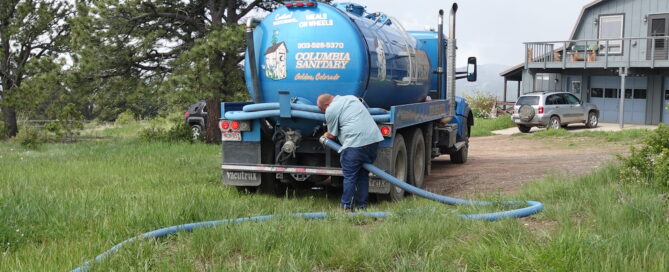 septic pump truck with man grabbing hose