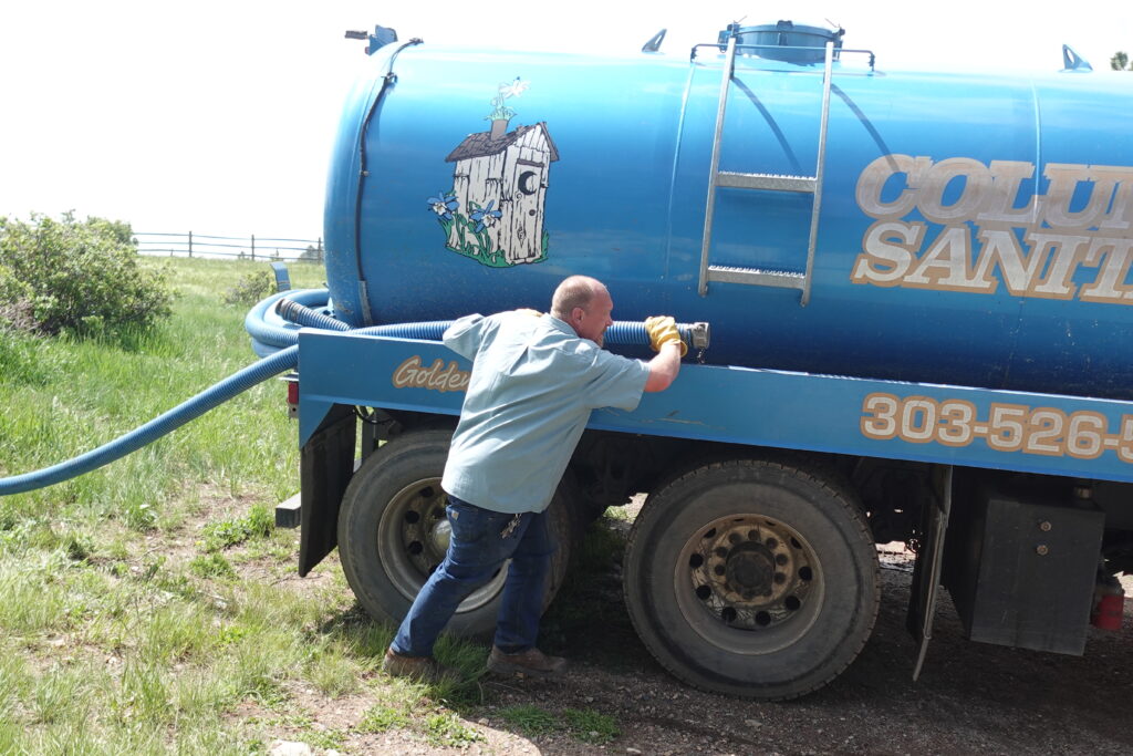 man with septic pump truck