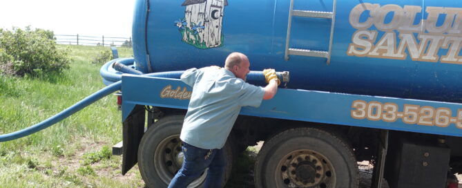 man with septic pump truck