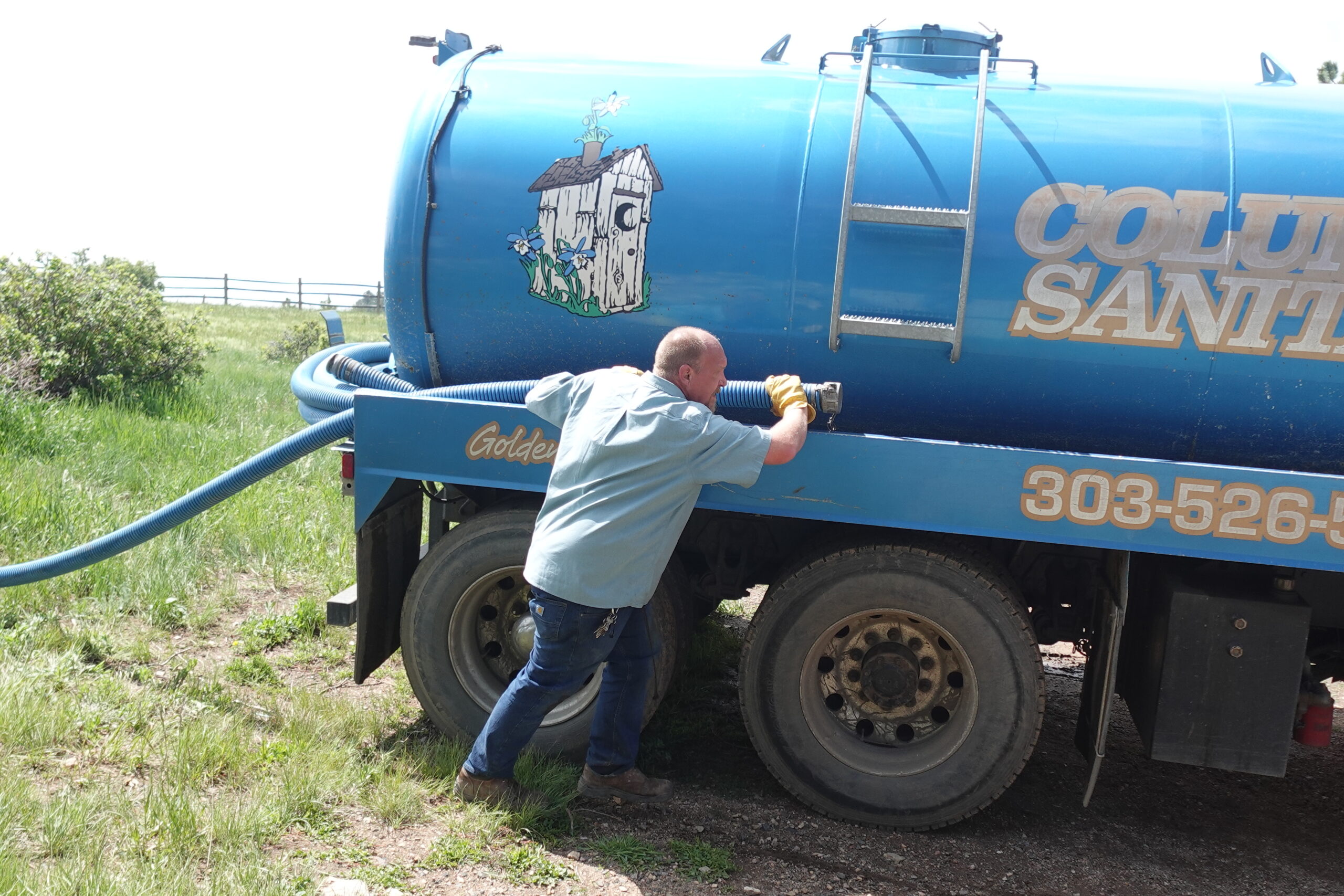 man with septic pump truck