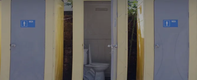 3 porta potties, 1 door open - History of the Porta Potty - ServiceCore Blog