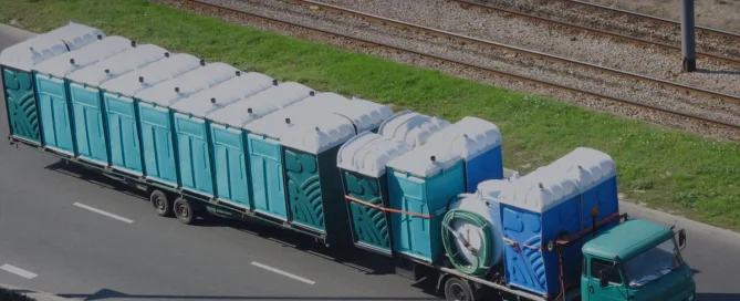 Truck transporting portable toilet units - How Many Toilets Do You Need to Start Portable Restroom Business? - ServiceCore Blog