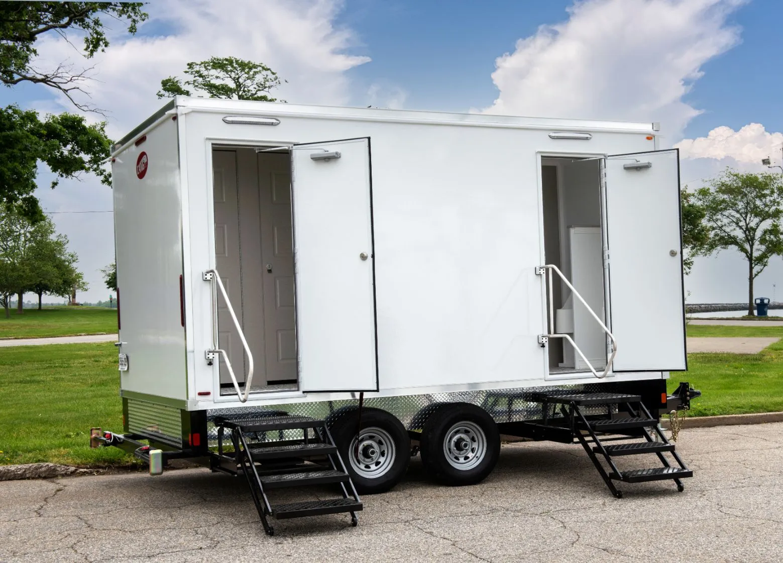 White luxury portable restroom trailer parked on a curb - Why Your Porta Potty Rental Business Needs ADA-Approved Units - ServiceCore Blog