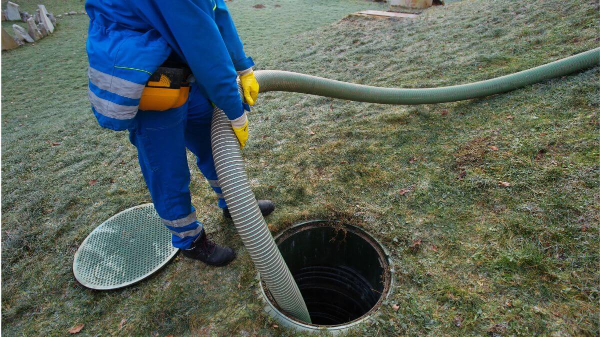 septic technician pumping a septic tank | do you need a license to pump septic tank | ServiceCore software for portable restroom & dumpster companies