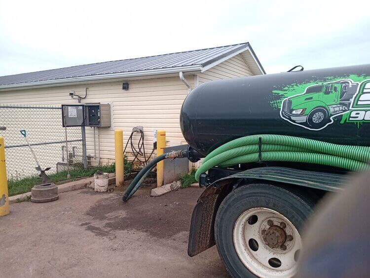 septic tank pulled up to house |  managing septic tank customers on the go | ServiceCore software for portable restroom & dumpster companies”