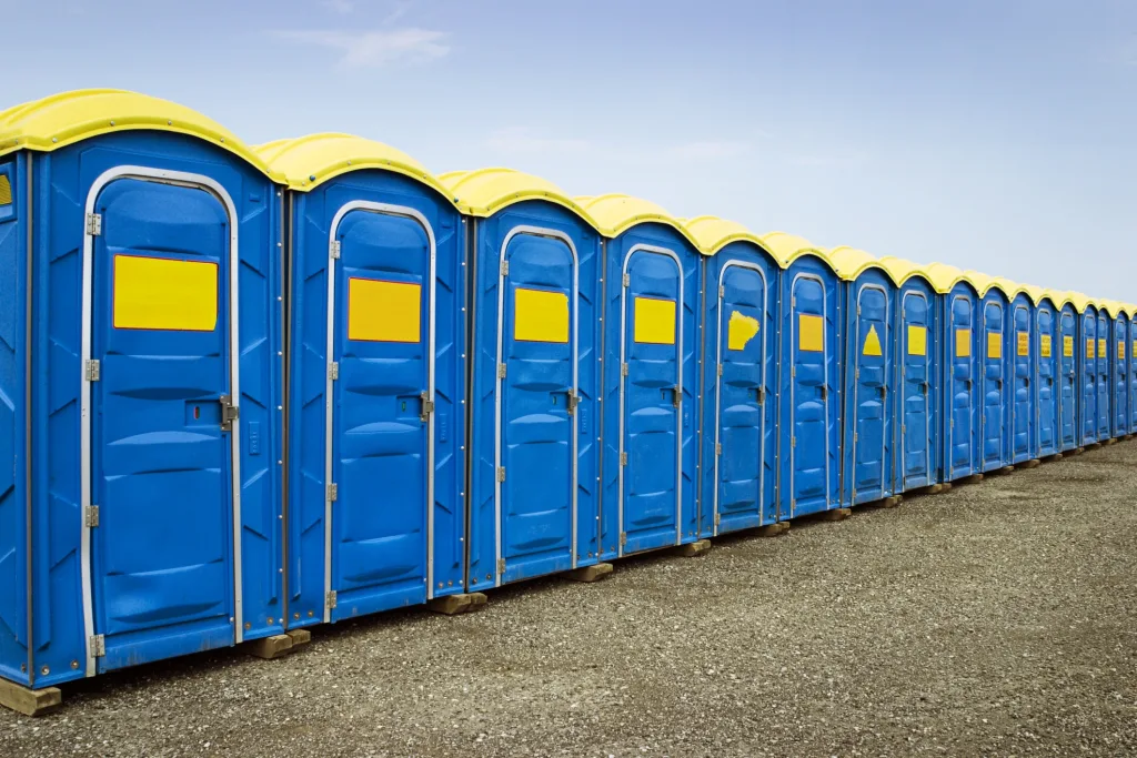 giant row of blue and yellow porta potties - maintenance checklist for PROs - ServiceCore software for portable restroom & dumpster companies