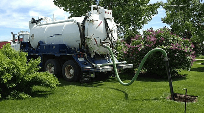 septic truck company hosing backyard | Growth Opportunities in Septic Cleaning Business| ServiceCore software for portable restroom & dumpster companies