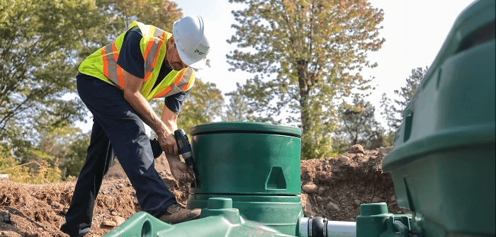 septic tank technician working on septic tank| creating a septic tank business plan | ServiceCore software for portable restroom & dumpster companies”