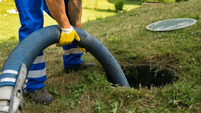 Septic tank technician pumping septic tank / 3 reasons to start a septic services business | ServiceCore software for portable restroom & dumpster companies