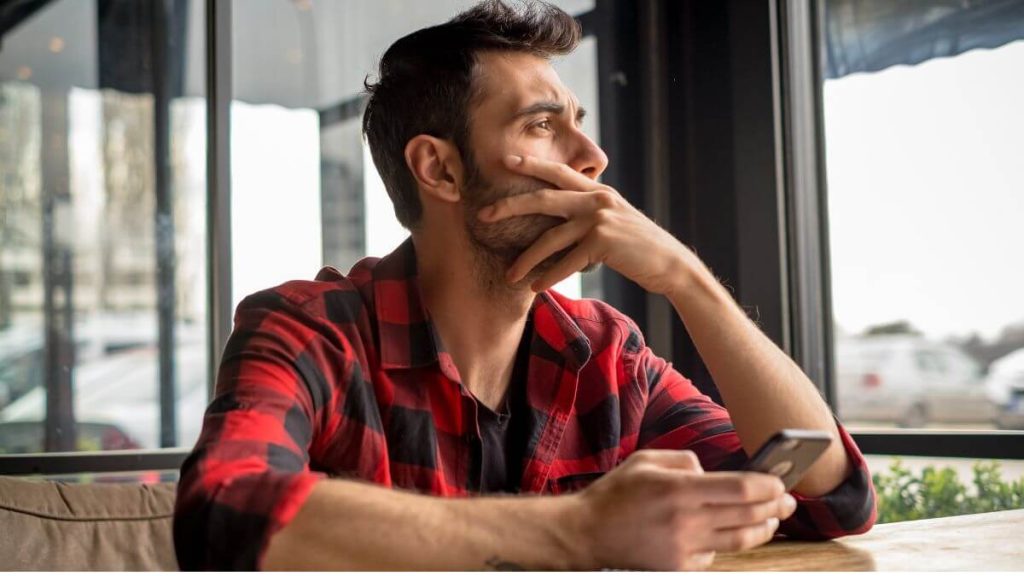 man looking out window looking stressed | Starting septic waste company 2023 | ServiceCore software for portable restroom & dumpster companies