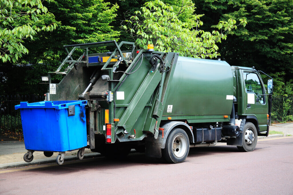 dumpster truck pulling trash | what you'll need to run a septic system business | ServiceCore software for portable restroom & dumpster companies”