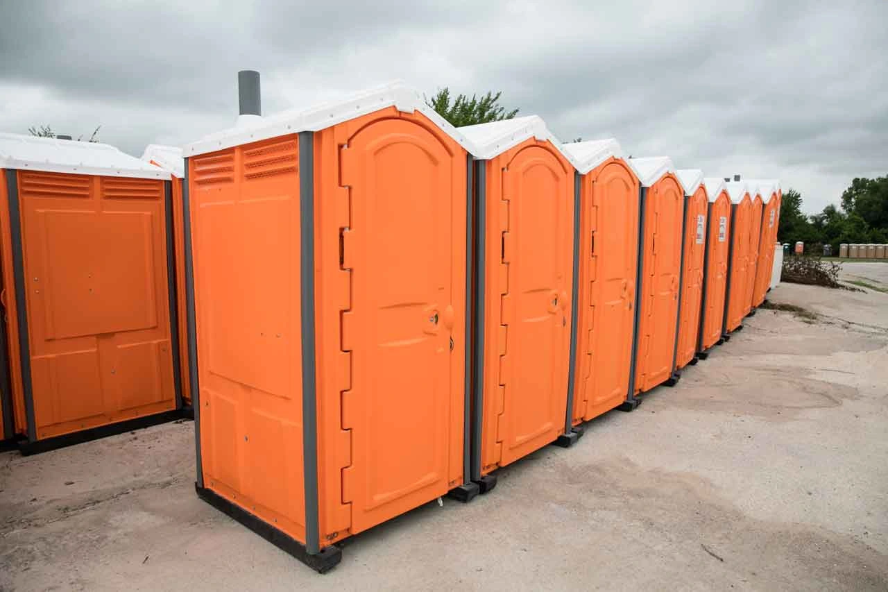 Multiple orange porta potties - Common Bizarre and Disgusting Things Found in Porta Potties - ServiceCore Blog