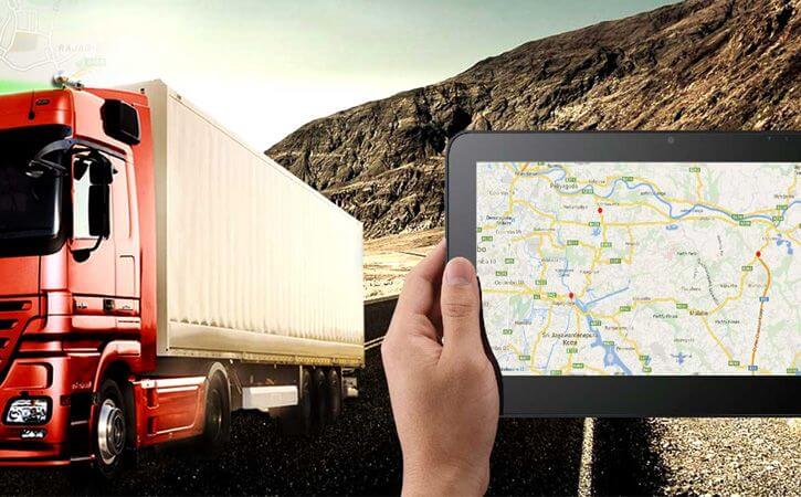 man holding tablet looking at incoming truck | route optimization for septic tank routing | ServiceCore software for portable restroom & dumpster companies”