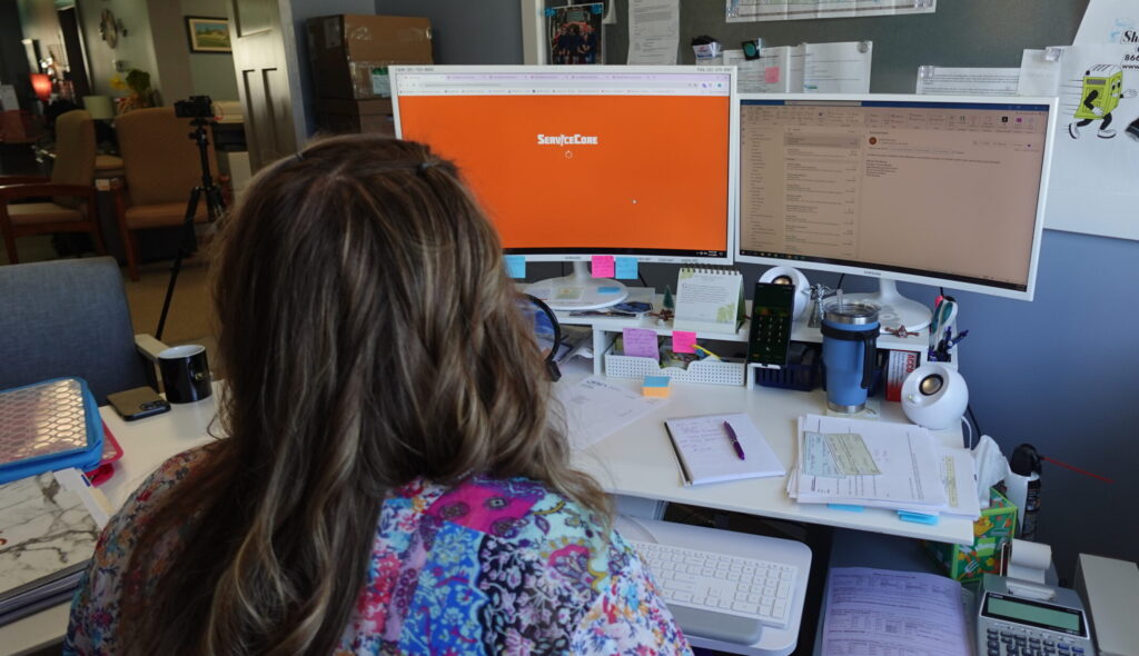 office staff member logging into their ServiceCore sign in portal on their office desktop computer.